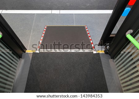 Retractable ramp for wheelchair at city bus