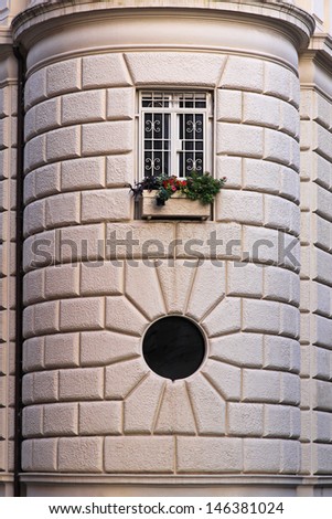 Round corner with windows at stone building