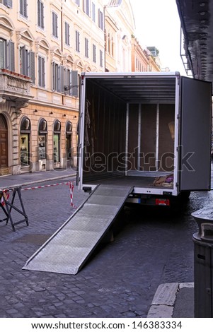 Empty moving truck with loading ramp at Rome street