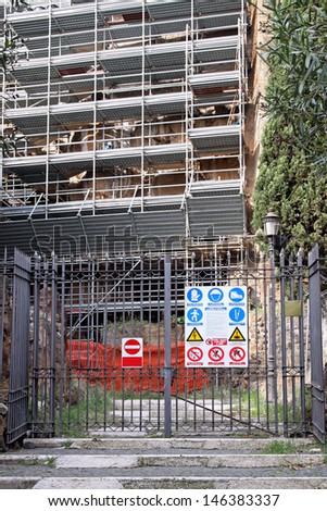 Construction site with scaffolding and safety fence