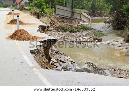 Destroyed road left with debris after river flooding