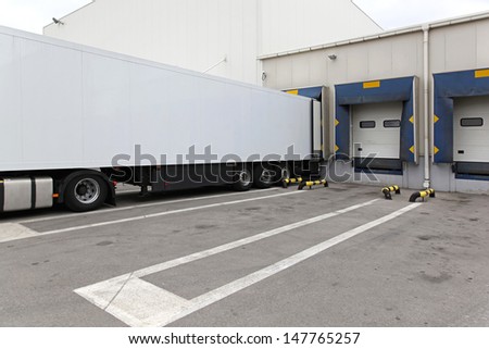 White box semi trailer at warehouse loading bay