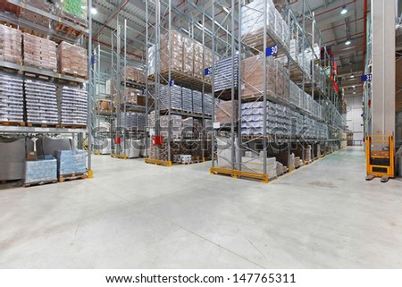 Shelves with goods in distribution center warehouse
