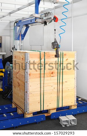 Wood crate secure packing at conveyor rollers
