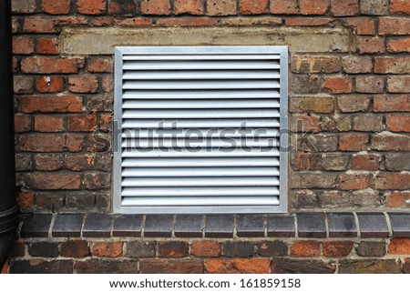 House ventilation grill on brick wall facade