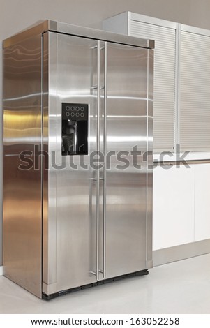 Big double fridge with ice maker in kitchen