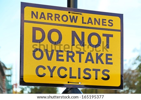 Do not overtake cyclist yellow traffic sign