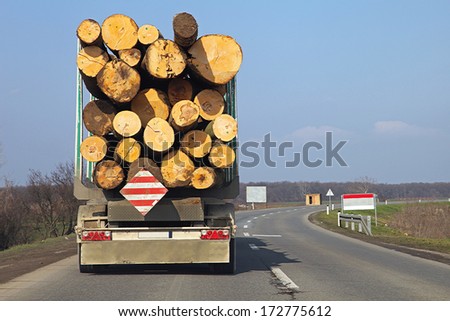 Logging lorry carry wooden logs at road