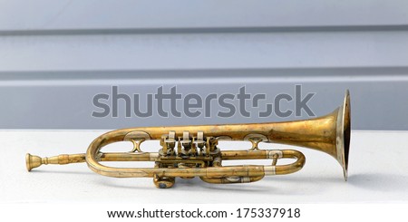 Old battered and bended trumpet in bad condition
