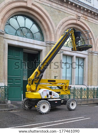 Yellow articulated boom lift for construction work
