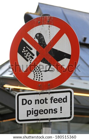 Do not feed the pigeons sign with droppings