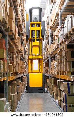 High rack stacker forklift truck in warehouse row