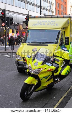 LONDON, UNITED KINGDOM - DECEMBER 28: Ambulance responder in London on DECEMBER 28, 2009. Ambulance motorcycle and emergency van at street in London, United Kingdom.