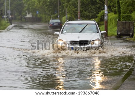 BELGRADE, SERBIA - MAY 15: Flood in Belgrade on MAY 15, 2013. Driving through flooded street after river Sava overflow in Belgrade, Serbia.