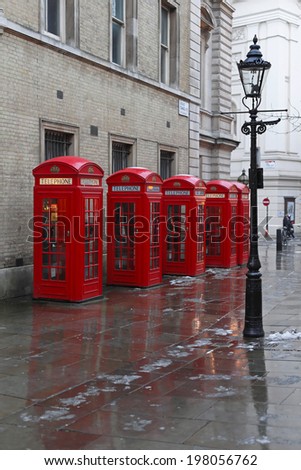 LONDON, UNITED KINGDOM - JANUARY 19: Red Telephone boxes in London on JANUARY 19, 2013. Gas Lighting and Five red telephone booths at West End in London, United Kingdom.