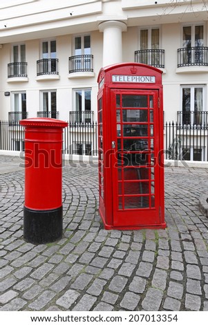 LONDON, UNITED KINGDOM - JANUARY 25: Phone box and red post box in London on JANUARY 25, 2013. Red telephone booth and Royal Mail box at St Katharine Docks in London, United Kingdom.