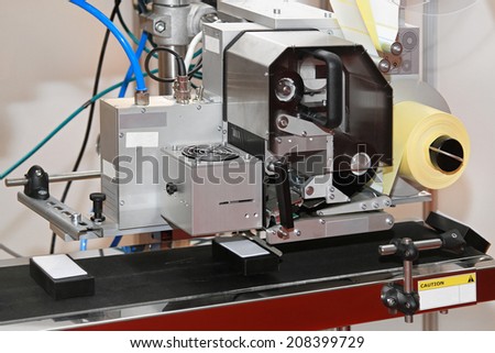 Label printer and applicator machine at conveyer belt