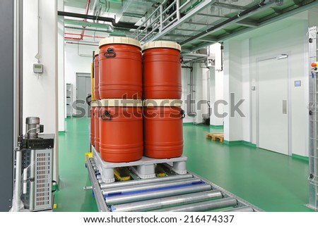Plastic barrels at automated storage and retrieval system in warehouse