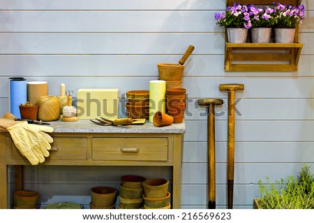 Bunch of gardening tools lying on wooden table