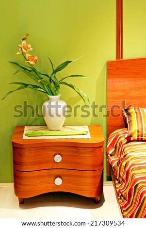 Flower in vase at bedside cabinet