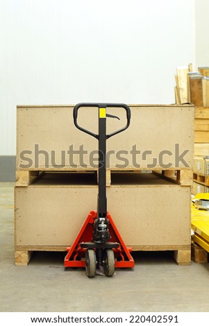 Pallet jack with big wooden crates boxes