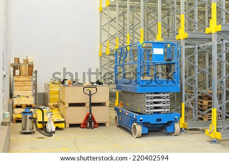 Scissor lift at construction site in distribution warehouse