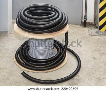 Cable coil and plastic hose for electric installation