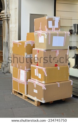 Merchandise in boxes at pallet delivery in front of shop