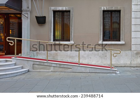 Wheelchair ramp with red carpet for easy access in building