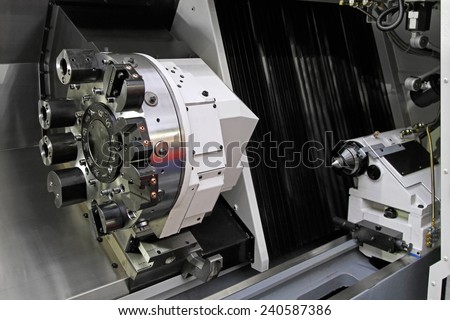 Rotating head at CNC lathe in workshop