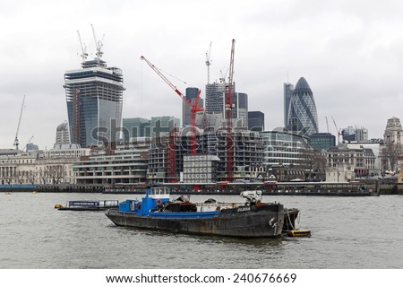 LONDON, UNITED KINGDOM - JANUARY 25: Skyscraper construction site in London on JANUARY 25, 2013. Building site at City view from Thames River in London, United Kingdom.