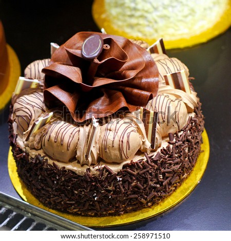 Tasty chocolate cake with flower decoration on top