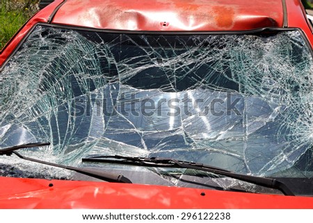 Broken Windshield at Red Car in Traffic Accident