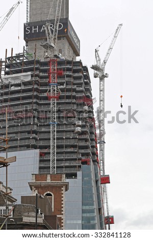LONDON, UNITED KINGDOM - OCTOBER 15, 2010: The Shard Skyscraper Construction Site. Cranes at Tall Building Tower During Construction in Southwark, London, England.