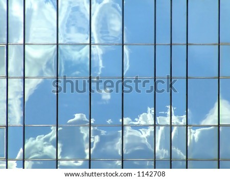Clouds reflection in mirror building