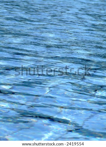 Light blue water in a big swimming pool