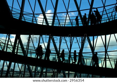 Silhouettes of people in front of big window