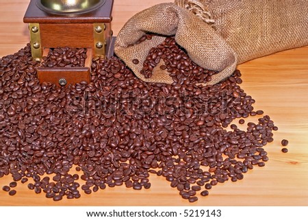 Coffee grinder and sack with lot of coffee beans