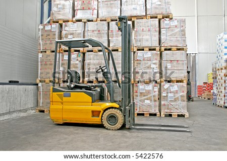 Yellow fork lifter truck and cargo boxes