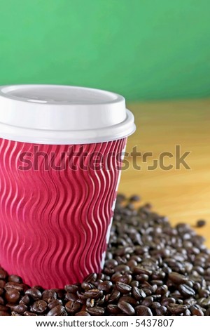 Take away coffee cup with roasted coffee background