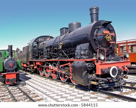 Small and big locomotive train on the tracks