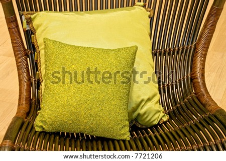 Two green pillows on the arm chair