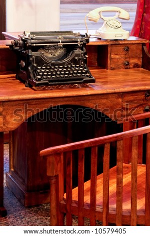 Vintage typewriter and white telephone on the desk