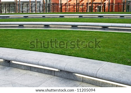 Grass area in park with concrete bench