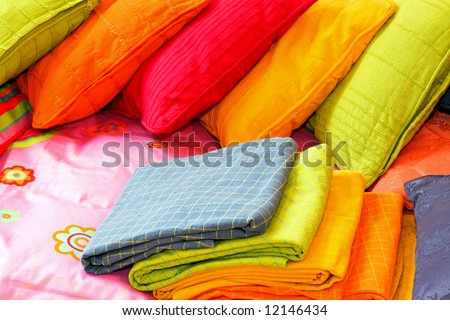 Bunch of colorful pillows and blankets for bed