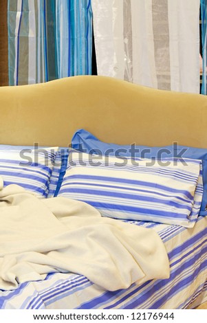 Two blue pillows with straps on double bed