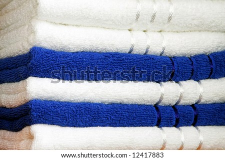 Stack of dry soft towels blue and white