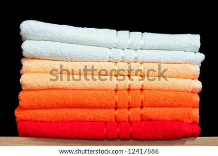 Stack of dry soft towels on shelf