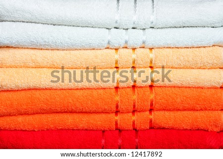 Stack of dry soft towels in warm colors