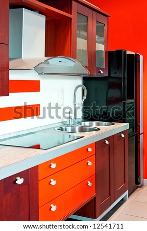 Contemporary red kitchen with big black fridge